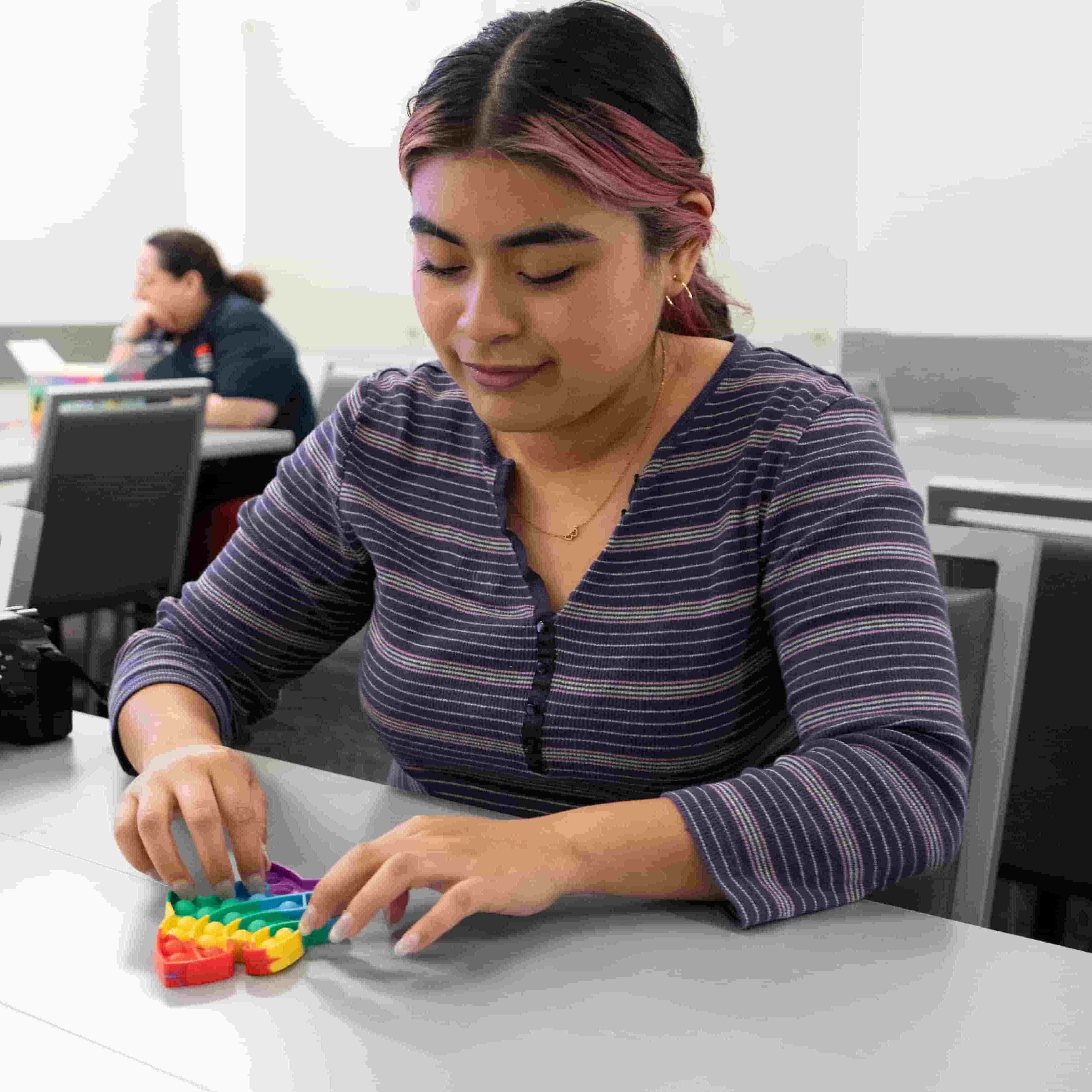 student playing with fidget toy